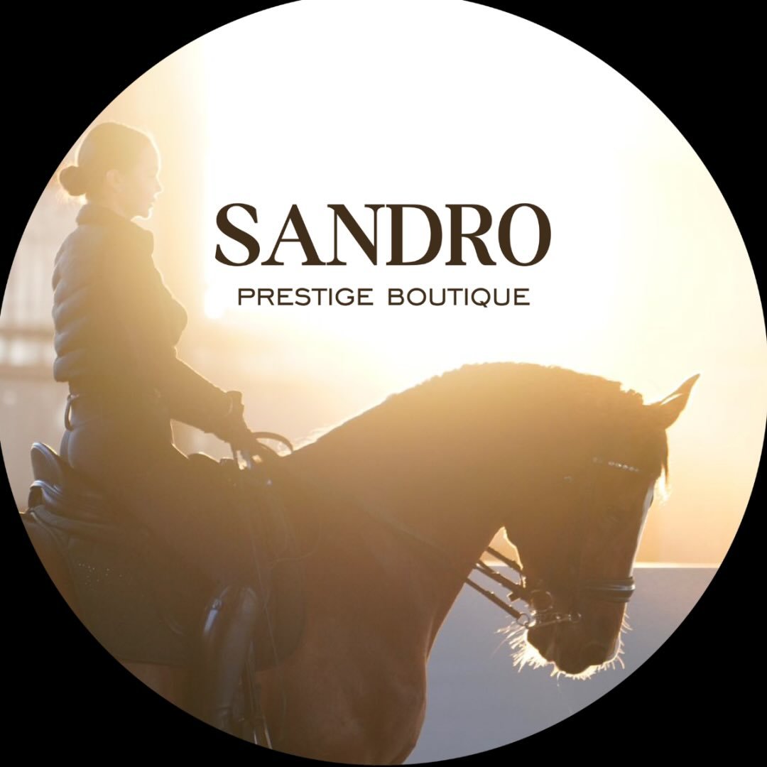 Аватар профиля: надпись Sandro Prestige Boutique на фоне всадницы на гнедой лошади в контровом солнечном свете